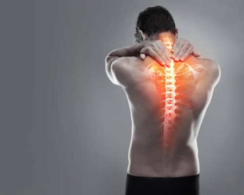 a man holding his back in pain
